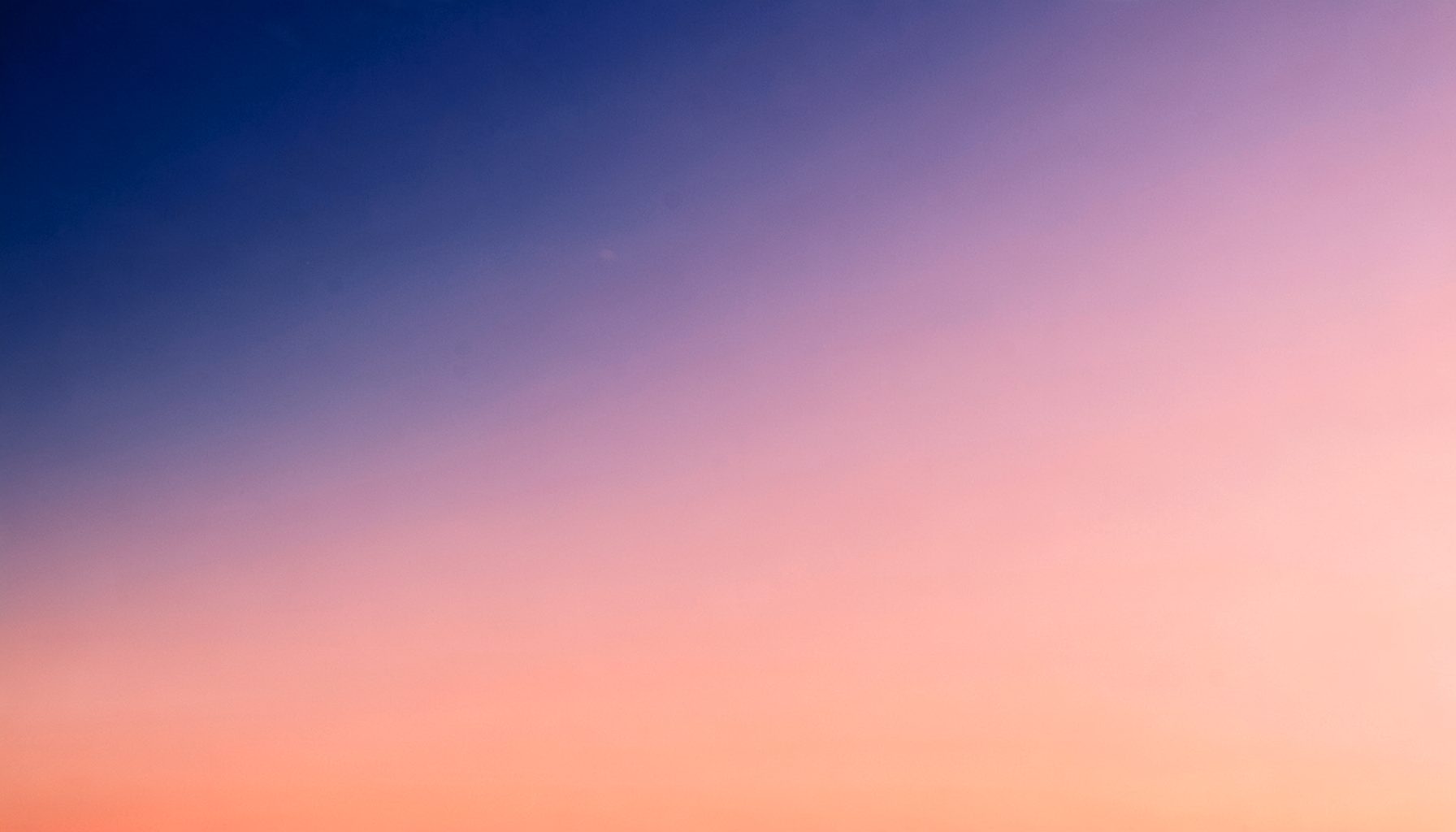 Warm atmospheric gradient from deep indigo to soft coral, suggesting global connectivity and world stories